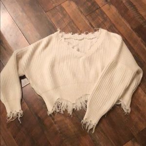 Cropped, distressed sweater